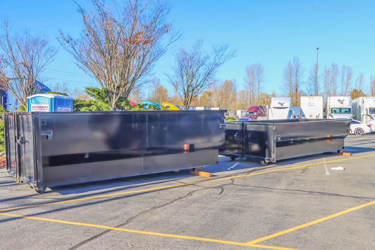 Professional dumpster rental service with roll-off container on residential driveway in Upper Chichester